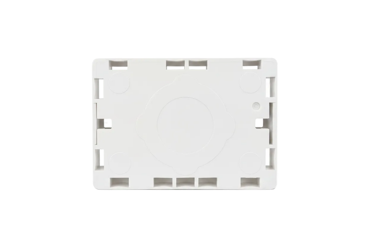 A white plastic mounting plate or bracket, sealed inside a clear plastic hanging bag, shown against a plain white background.