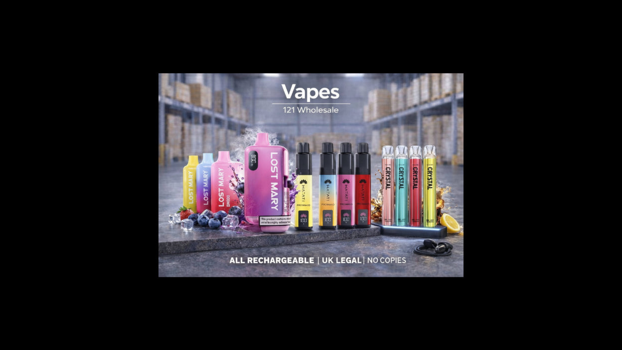 Display of various vapes with branding in a warehouse setting.